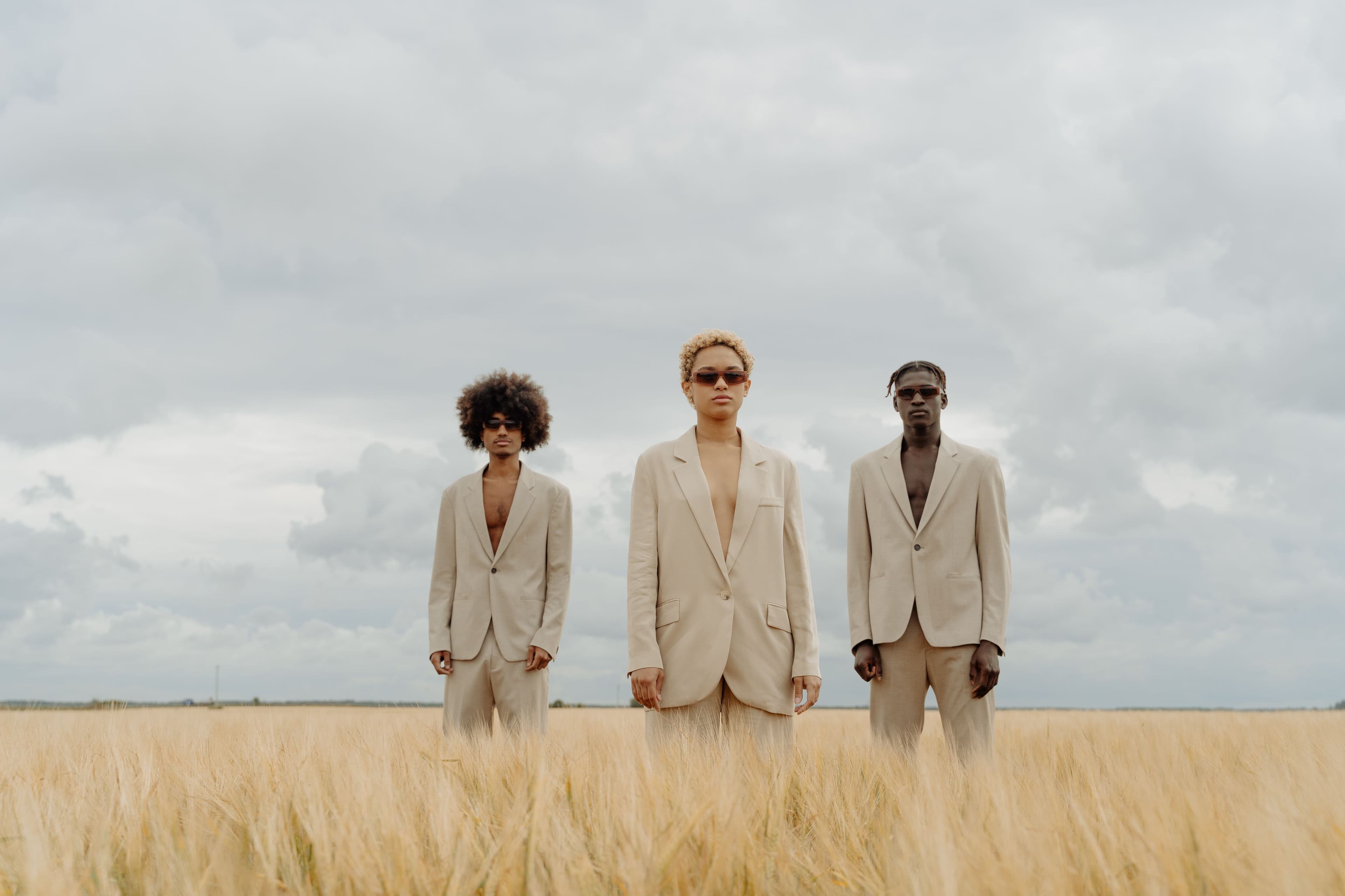 Two models walking through a wheat field