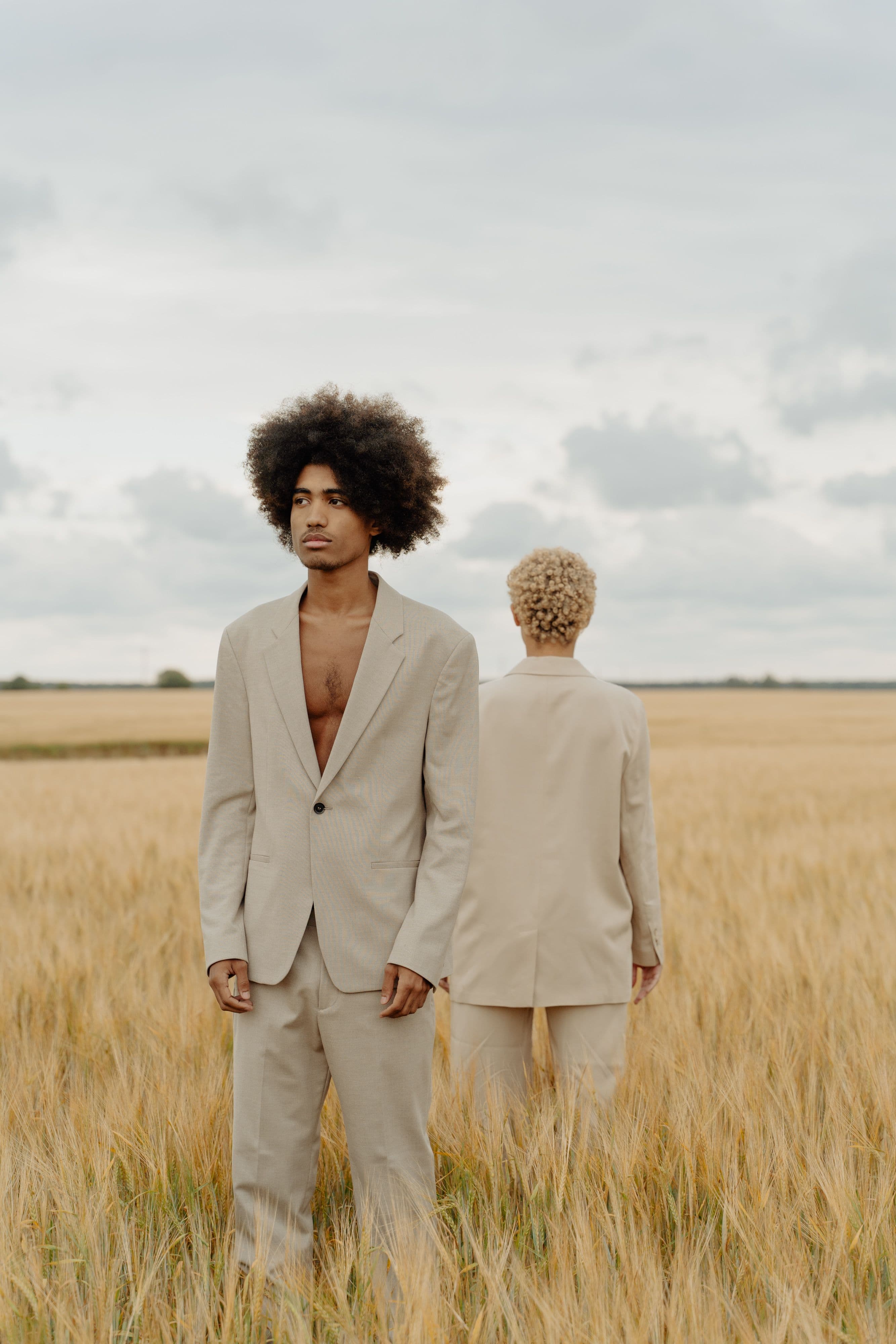 A portrait of two models in a wheat field