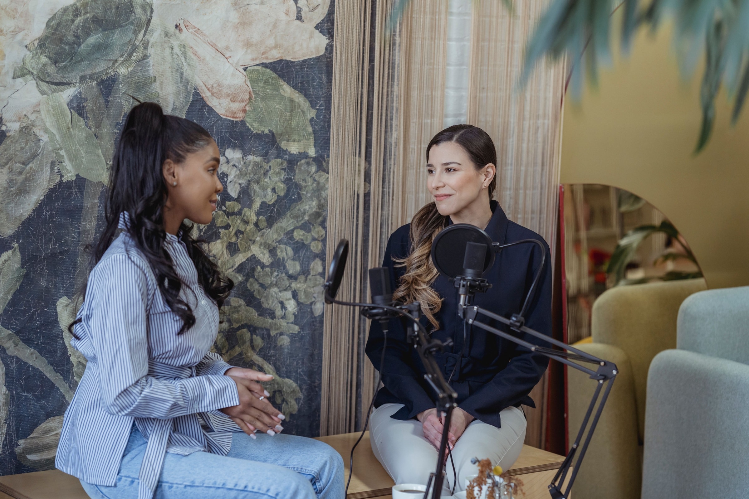 Two podcast hosts recording an interview