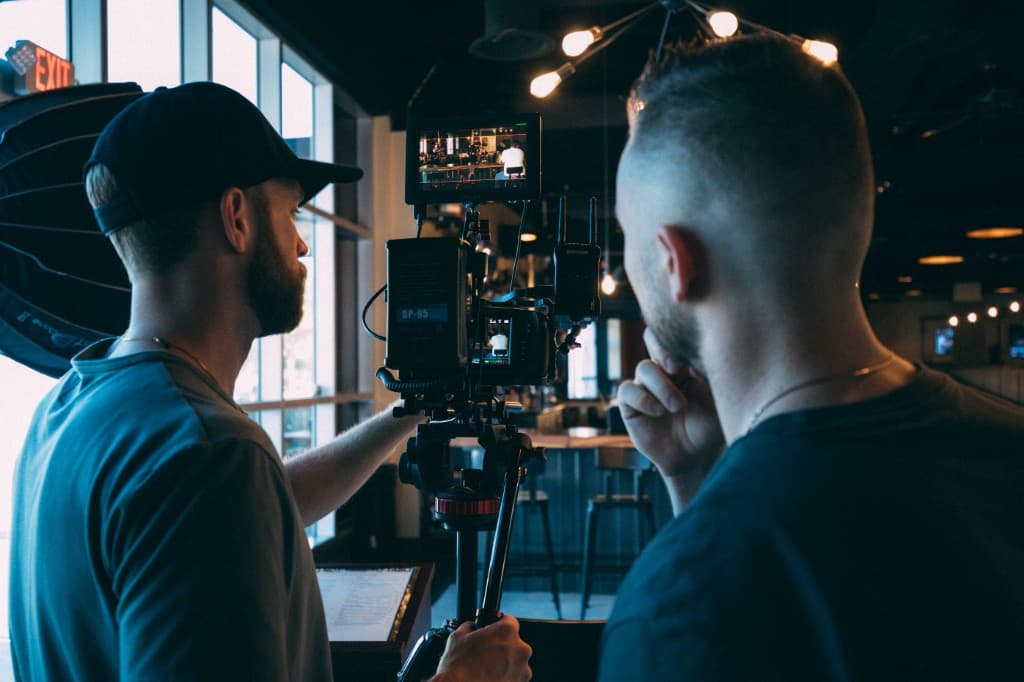 Two crew members reviewing a shot on a cinema camera