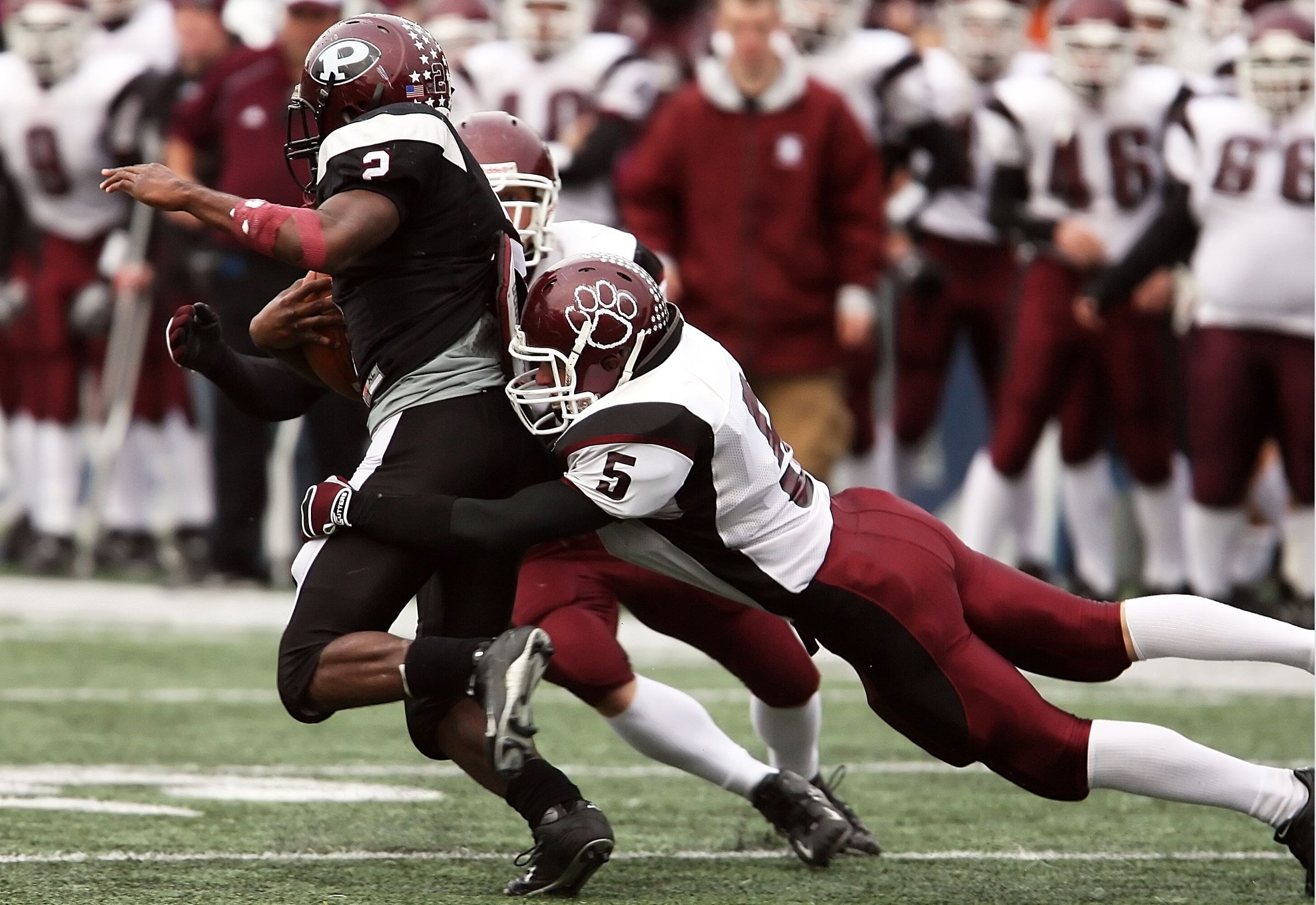 American football tackle on the field